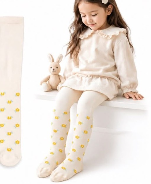 Child wearing a cream Kiddy Trends winter outfit