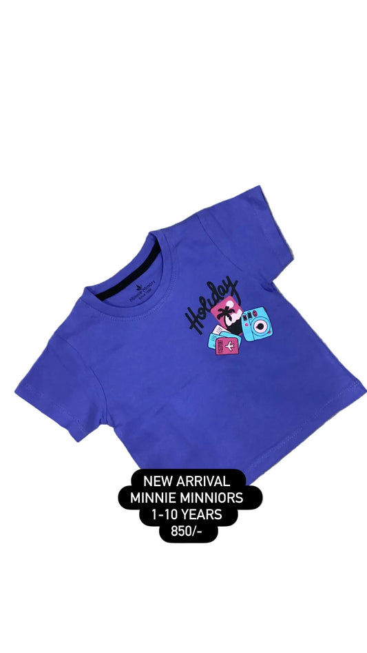 Blue t-shirt with cartoon character on a textured surface with flowers in the background