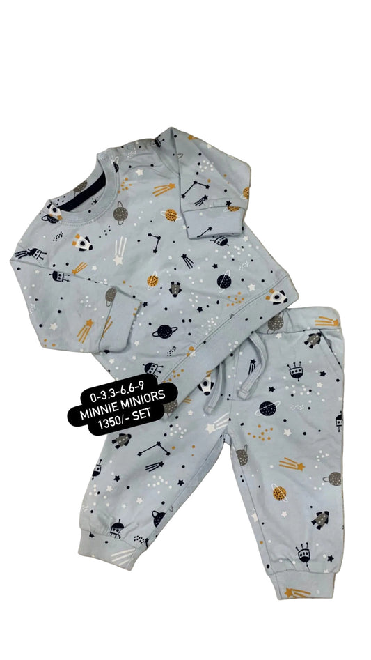 Children's pajama set with animal pattern on a textured surface