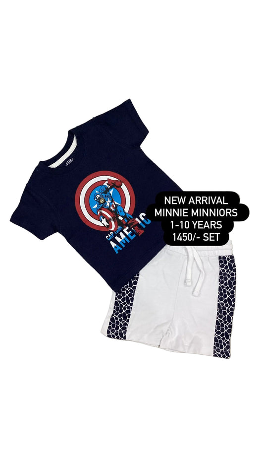 Navy blue t-shirt with superhero design and white shorts on a textured surface.