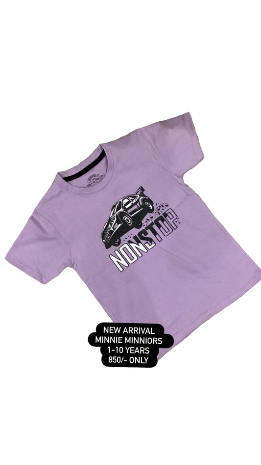 Purple t-shirt with a graphic design on a fluffy white surface with flowers.