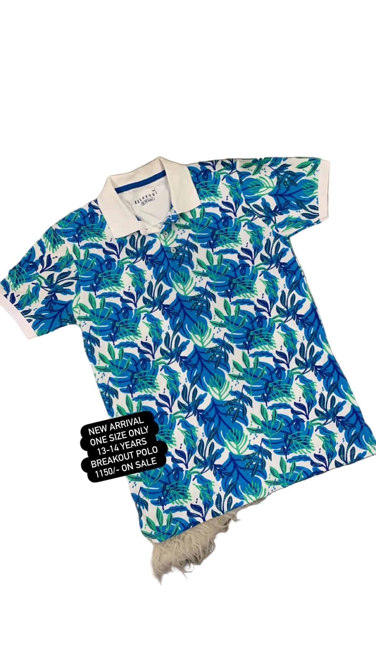 Blue floral patterned shirt on a textured surface with flowers in the background