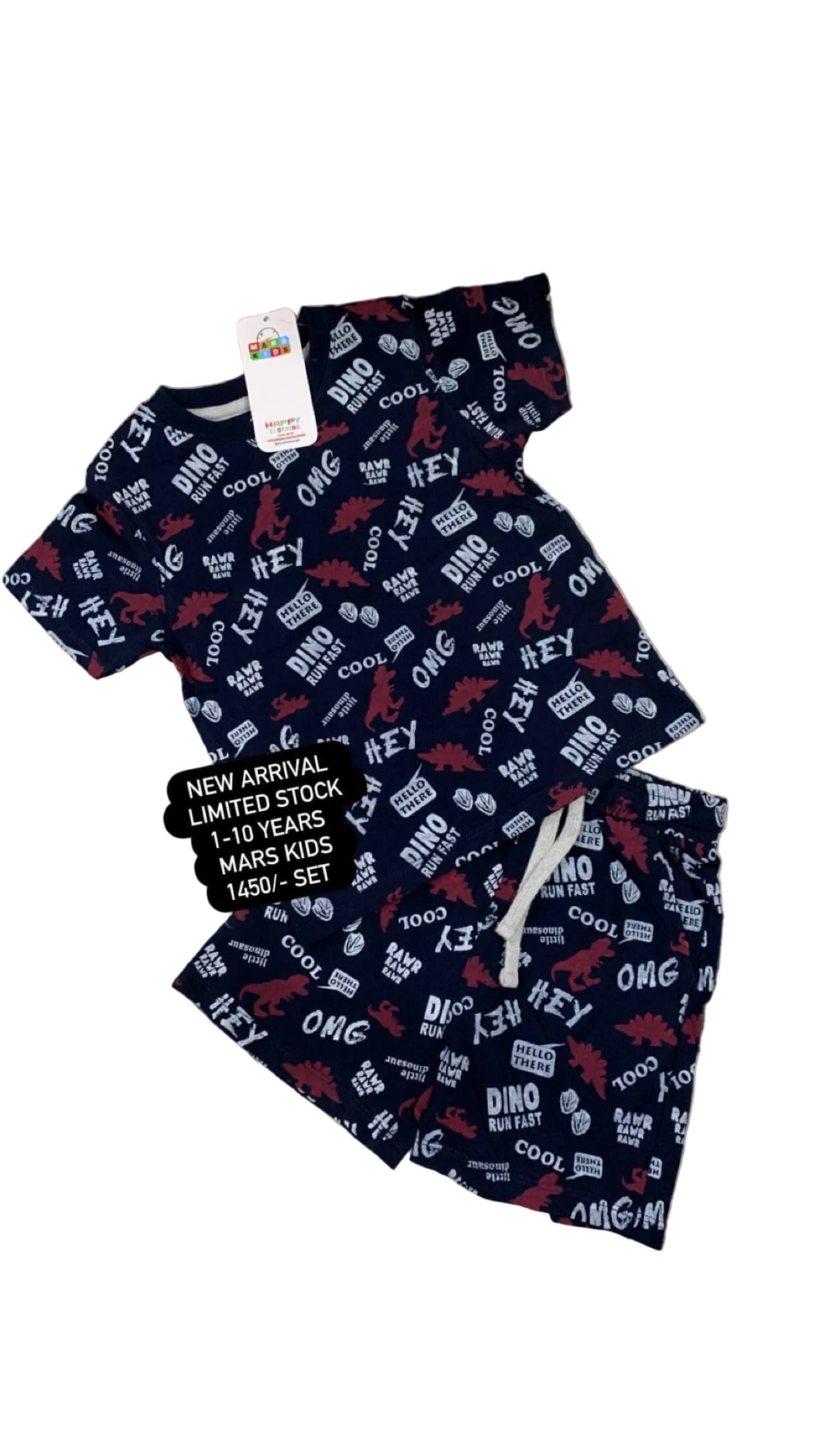 Children's navy pajama set with text pattern on a fluffy white surface with flowers in the background.