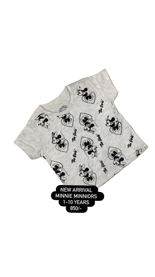 Gray shorts with black patterns on a textured surface with white flowers in the background