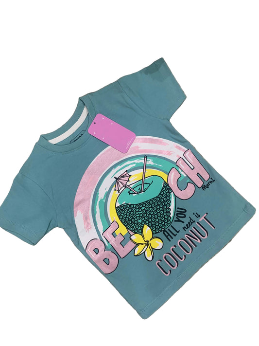 Blue t-shirt with a colorful graphic and text on a textured surface with flowers in the background