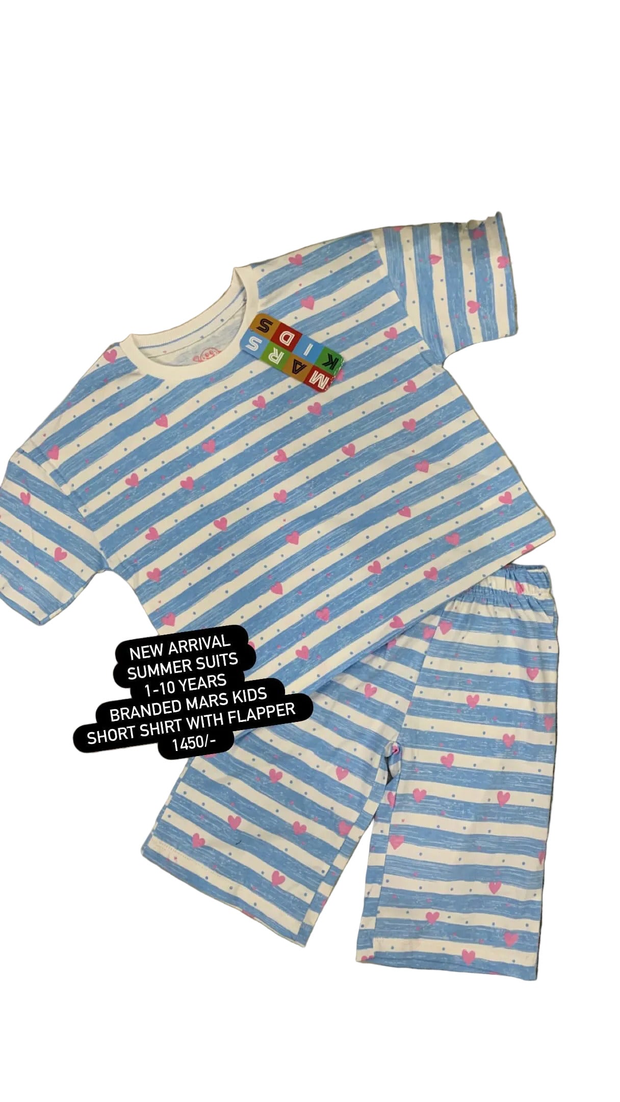 Blue and white striped children's shorts and shirt set on a textured surface with flowers in the background.