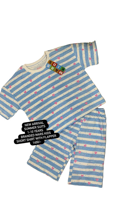 Blue and white striped children's shorts and shirt set on a textured surface with flowers in the background.