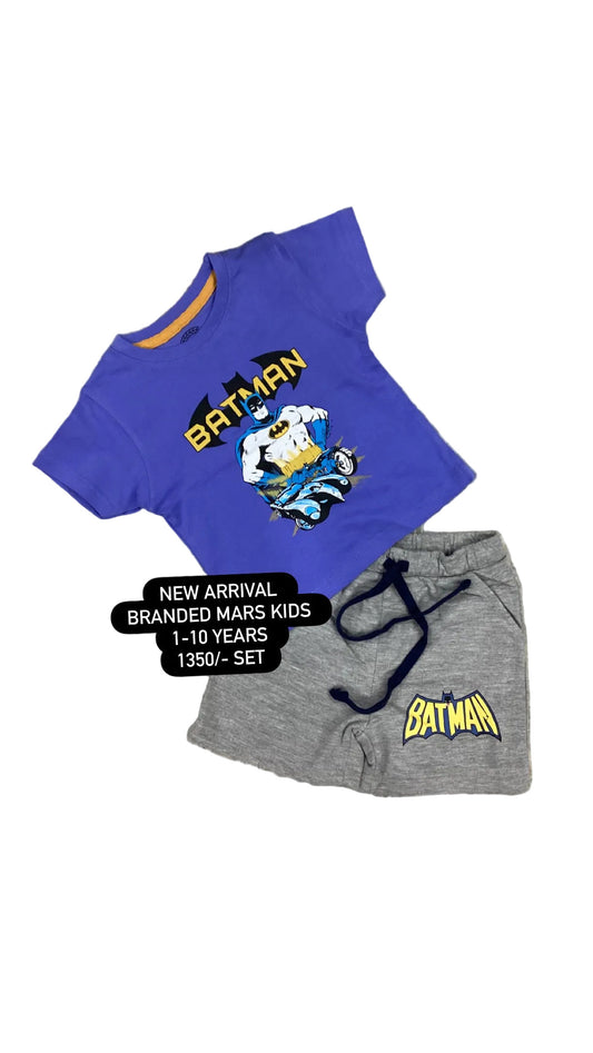 Blue t-shirt and gray shorts with Batman logo on a textured surface