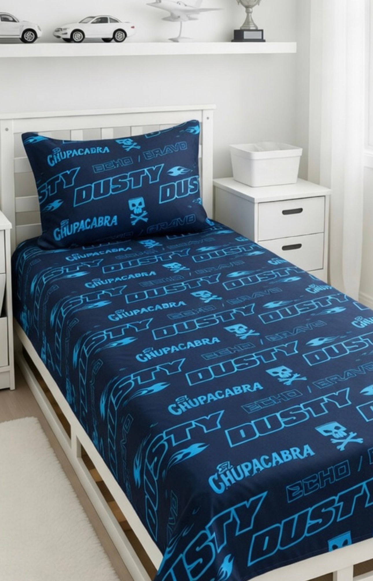 Bedding set with 'Chupacabra' and 'Dusty' branding on a bed in a room.
